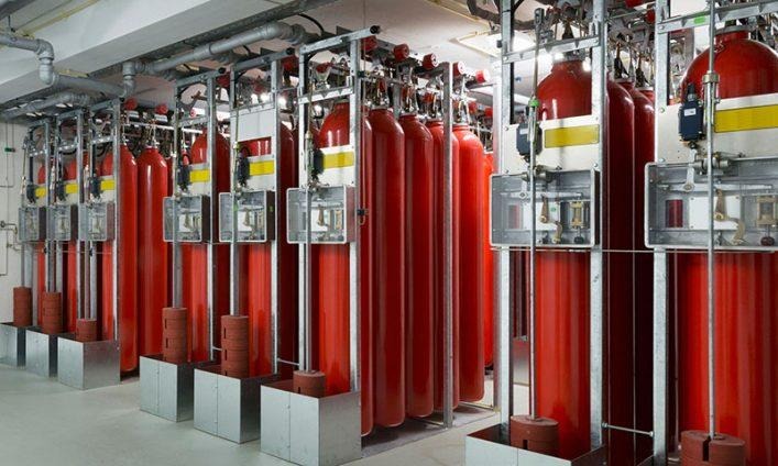 High-pressure red nitrogen gas storage cylinders installed in secure storage frames